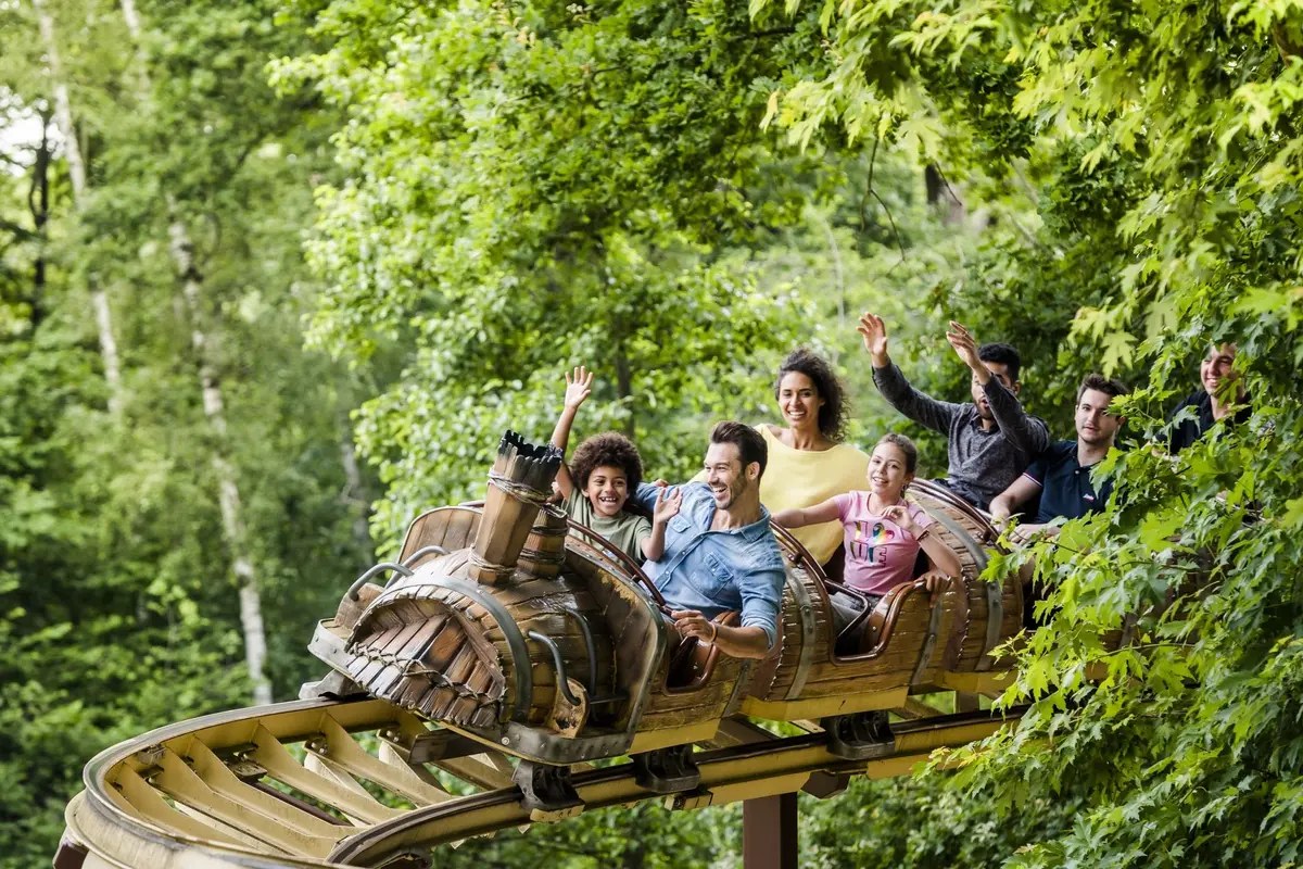 Manèges colorés et visiteurs dans un parc d'attraction en été